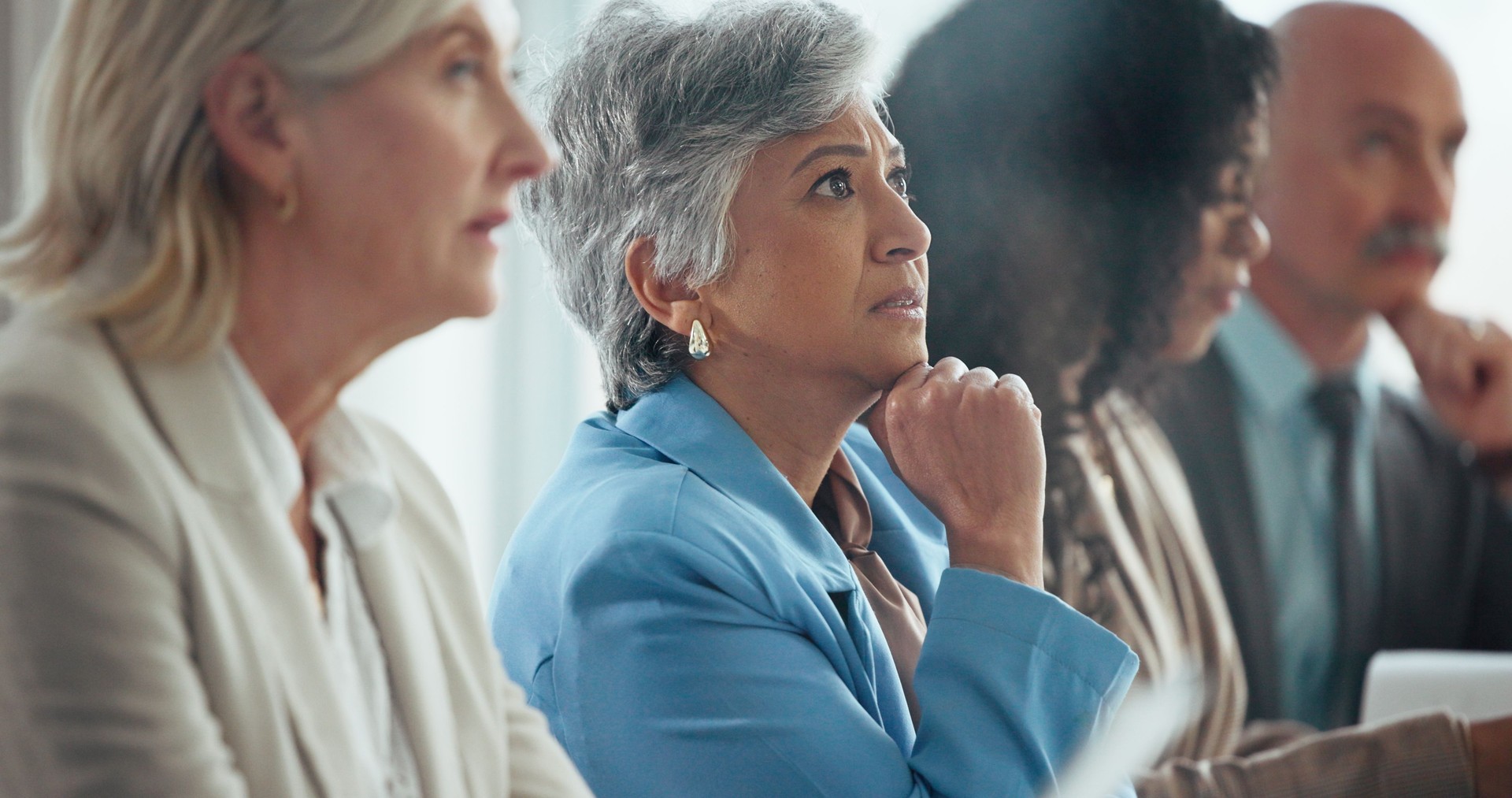 Business woman, listen and audience at conference, meeting and attention for announcement at company. Mature person, crowd and group of insurance employees, info and team at corporate convention