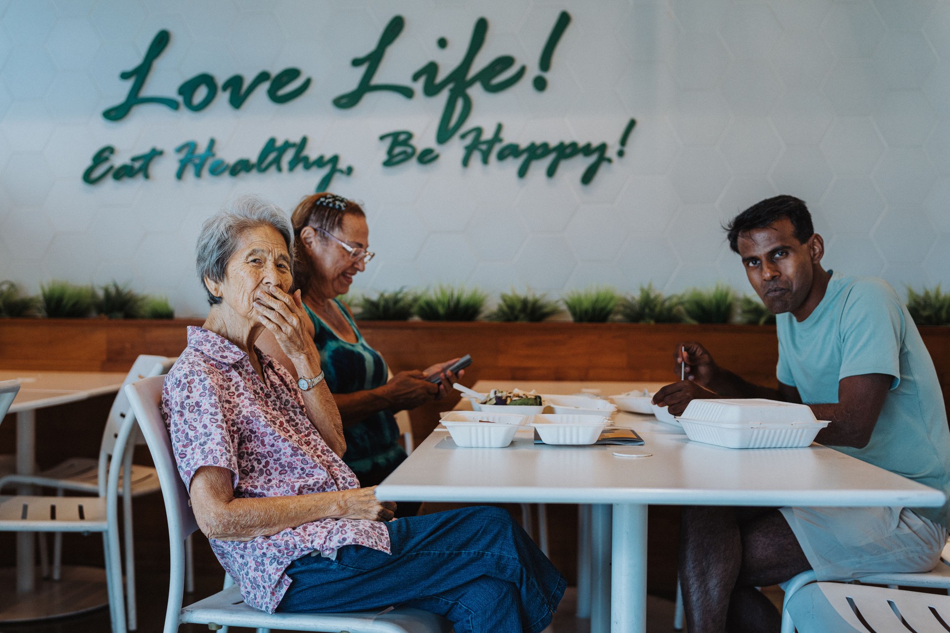 Elderly Korean woman eating lunch with friends